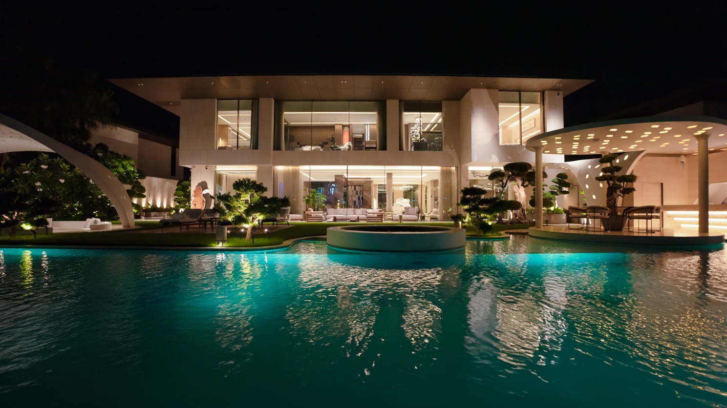 A Jumeirah Bay Island villa at night, pool lit, garden pavilion