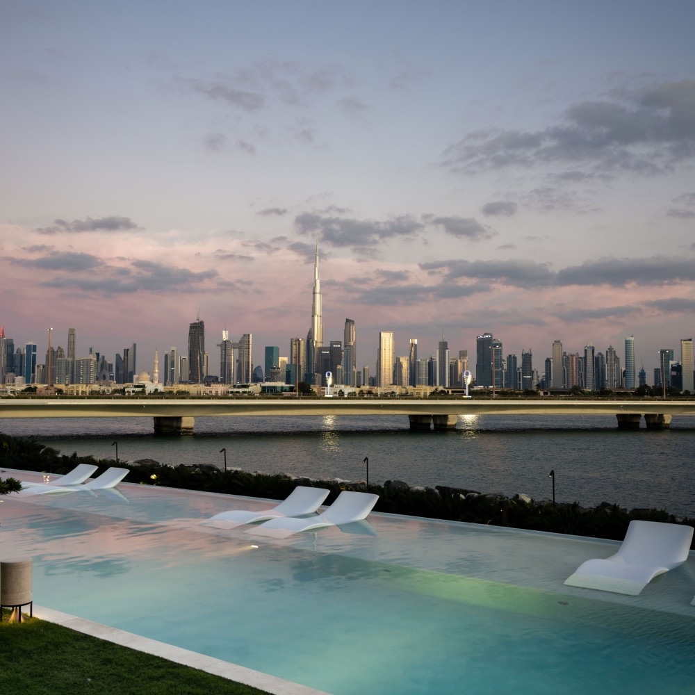 Infinity pool at dusk facing the Downtown Dubai skyline